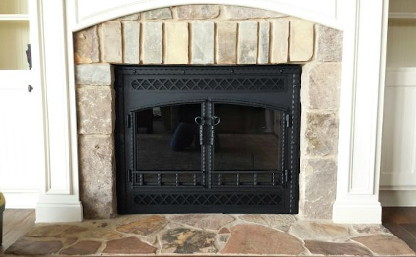 wood burning fireplace with glass doors