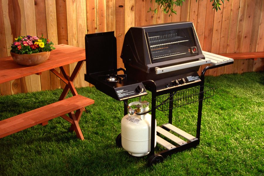 Person Flipping Burgers During BBQ